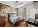 Comfortable bedroom with a world map mural, desk, and hardwood floors at 1858 Preserve Way, Atlanta, GA 30341