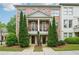Beautiful brick townhome featuring second story balconies, symmetrical evergreens, and manicured landscaping at 1858 Preserve Way, Atlanta, GA 30341