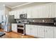 Well-equipped kitchen with stainless steel appliances, stone countertops, backsplash, and ample white cabinetry at 1858 Preserve Way, Atlanta, GA 30341