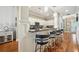 Modern eat in kitchen featuring bar seating, stainless steel appliances, granite countertops, and wood floors at 1858 Preserve Way, Atlanta, GA 30341