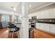 Eat in kitchen featuring bar seating, stainless steel appliances, granite countertops, and wood floors at 1858 Preserve Way, Atlanta, GA 30341