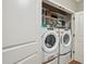 Convenient laundry room with a front-load washer and dryer set and plenty of shelving at 1858 Preserve Way, Atlanta, GA 30341