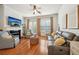 Cozy living room with fireplace, plush seating, hardwood floors, lots of light from large windows at 1858 Preserve Way, Atlanta, GA 30341