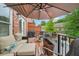 Cozy outdoor patio with a comfortable cushioned couch and a grill, perfect for relaxing and outdoor cooking at 1858 Preserve Way, Atlanta, GA 30341