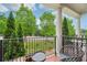 Outdoor porch with black wrought iron railings and seating with an open view at 1858 Preserve Way, Atlanta, GA 30341