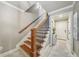 Elegant staircase with wood steps, decorative railing, and neutral walls at 1858 Preserve Way, Atlanta, GA 30341