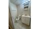 Half bathroom featuring tile floors and a vanity with storage at 3722 Cherokee Overlook Dr, Canton, GA 30115