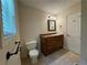 Bathroom with window, toilet, sink, mirror, and tiled flooring at 3722 Cherokee Overlook Dr, Canton, GA 30115