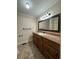 Bathroom vanity with drawers and cabinets, framed mirror, and tile floors at 3722 Cherokee Overlook Dr, Canton, GA 30115