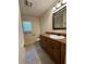 Bathroom featuring wood cabinets, sink, mirror, and tiled flooring at 3722 Cherokee Overlook Dr, Canton, GA 30115