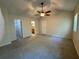Spacious bedroom featuring a ceiling fan, neutral carpeting, and access to a walk-in closet at 3722 Cherokee Overlook Dr, Canton, GA 30115