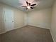 Carpeted bedroom with ceiling fan and multiple entry doors at 3722 Cherokee Overlook Dr, Canton, GA 30115