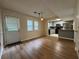 Open dining area with wood floors and a view of the updated kitchen with stainless appliances at 3722 Cherokee Overlook Dr, Canton, GA 30115