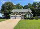 Charming home features a two-car garage, well-manicured lawn, and mature shade trees at 3722 Cherokee Overlook Dr, Canton, GA 30115