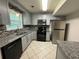 Modern kitchen featuring stainless steel appliances and sleek gray cabinets at 3722 Cherokee Overlook Dr, Canton, GA 30115