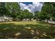 Large, well-maintained common area with mature trees and a grassy field at 720 Mountain Laurel Dr, Canton, GA 30114