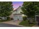 Two-story home featuring a two-car garage, a well-manicured lawn, and mature trees at 720 Mountain Laurel Dr, Canton, GA 30114