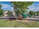 Community playground area with modern play equipment, surrounded by mature trees and grass at 720 Mountain Laurel Dr, Canton, GA 30114