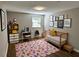 Bright bedroom with colorful rug, fun decorations, and ample natural light from a large window at 1387 Renee Dr, Decatur, GA 30035