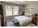 Bright bedroom with hardwood floors, large window overlooking the front yard, and a comfortable bench at 1387 Renee Dr, Decatur, GA 30035