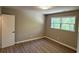 Neutral bedroom with two windows offering natural light and hardwood style floors at 1387 Renee Dr, Decatur, GA 30035