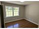Bright bedroom with hardwood floors, neutral walls, and a large window with backyard views at 1387 Renee Dr, Decatur, GA 30035