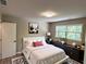 Cozy bedroom with plush bedding, stylish decor, and a large window offering natural light and views at 1387 Renee Dr, Decatur, GA 30035
