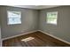 Neutral bedroom with two windows offering plenty of natural light and hardwood floors at 1387 Renee Dr, Decatur, GA 30035