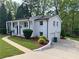 Charming white brick home with landscaped front yard and two-car garage at 1387 Renee Dr, Decatur, GA 30035
