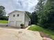 A two-story white brick home showing two garage doors and a concrete driveway at 1387 Renee Dr, Decatur, GA 30035