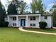 Charming brick home with a well-manicured lawn and a welcoming blue front door at 1387 Renee Dr, Decatur, GA 30035