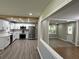 Modern kitchen featuring stainless steel appliances, white cabinets, and hardwood-style flooring at 1387 Renee Dr, Decatur, GA 30035