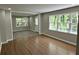 Open living room with hardwood floors, three large windows and neutral color palette at 1387 Renee Dr, Decatur, GA 30035
