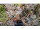 Aerial perspective showcasing dense trees surrounding property at 176 Old Burnt Hickory Rd, Douglasville, GA 30134