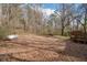Backyard with trees and a propane tank, suitable for outdoor entertaining, relaxing, and recreation at 176 Old Burnt Hickory Rd, Douglasville, GA 30134