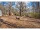 A spacious backyard with storage buildings and rustic features, perfect for outdoor activities and storage at 176 Old Burnt Hickory Rd, Douglasville, GA 30134