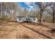 Exterior of a charming home with a small front porch and ample natural light, surrounded by a wooded lot at 176 Old Burnt Hickory Rd, Douglasville, GA 30134