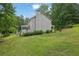 Large backyard features a covered porch, landscaped yard and mature trees offering plenty of shade at 1925 Stonewyck Ct, Cumming, GA 30041