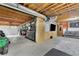 Unfinished basement with high ceilings, wood beams, work bench and an entertainment space at 1925 Stonewyck Ct, Cumming, GA 30041