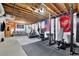 Spacious basement featuring a workout area, weightlifting rack and recreational space at 1925 Stonewyck Ct, Cumming, GA 30041