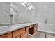 Beautiful bathroom featuring double vanity, marble countertops, soaking tub and stylish fixtures at 1925 Stonewyck Ct, Cumming, GA 30041
