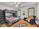 bedroom featuring a bunk bed with a ladder, two windows and hardwood floors at 1925 Stonewyck Ct, Cumming, GA 30041