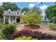 Charming community clubhouse with blue siding, dormer windows, and beautiful landscaping, complemented by a brick walkway at 1925 Stonewyck Ct, Cumming, GA 30041