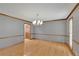 Formal dining room with decorative trim, hardwood floors and a chandelier at 1925 Stonewyck Ct, Cumming, GA 30041