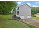 Two-story home with a two car garage, steps and manicured landscaping in a peaceful, green setting at 1925 Stonewyck Ct, Cumming, GA 30041