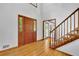 Inviting entry foyer with hardwood floors, a staircase and ample natural light at 1925 Stonewyck Ct, Cumming, GA 30041