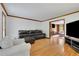 Spacious living room featuring hardwood floors, white walls, comfortable seating and lots of light at 1925 Stonewyck Ct, Cumming, GA 30041