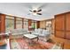 Bright living room with a large window, hardwood floors, white sofas, and a patterned rug, creating a cozy space at 1925 Stonewyck Ct, Cumming, GA 30041