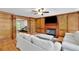 Spacious living room featuring hardwood floors, built-in bookshelves, a fireplace and white sofas for comfortable seating at 1925 Stonewyck Ct, Cumming, GA 30041