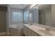 Bathroom featuring double sinks, soaking tub, a large mirror, and fresh paint at 2157 Brandon Lee Sw Dr, Marietta, GA 30008